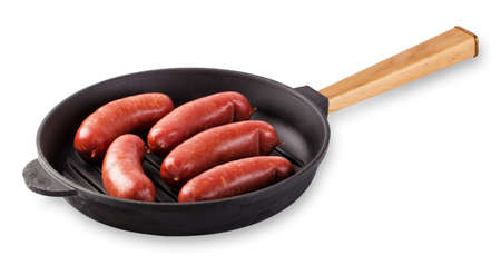 Sausages in a frying pan with a wooden handle isolated on whiteの写真素材