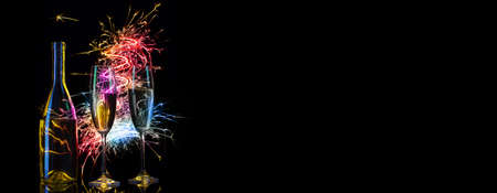 Festive champagne in multicolored sparks of lightsの写真素材