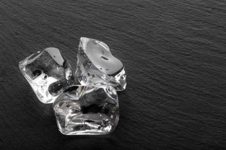 Large ice cubes on black slateの写真素材
