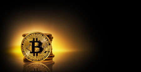 Virtual currency bitcoin against the background of stack of coins. The concept of developing a new virtual currency. Toning.の写真素材