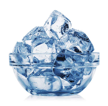 Ice cubes with water droplets in transparent plateの写真素材