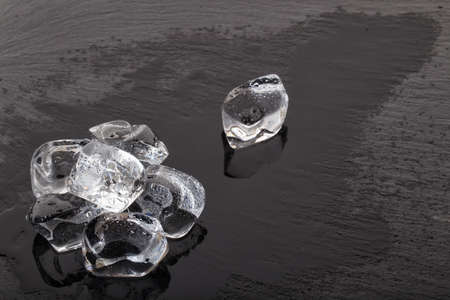 Large ice cubes on black slate boardの写真素材