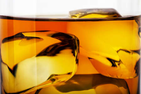 Fragment of glass of whiskey with iceの写真素材