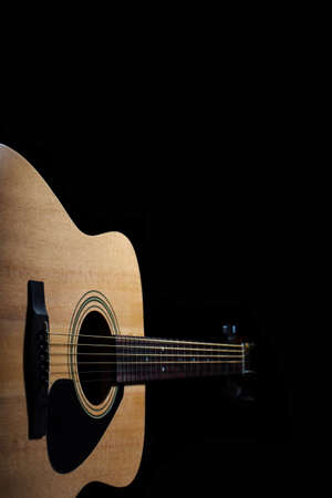 Acoustic guitar on black backgroundの写真素材