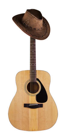 Acoustic guitar with hanging hat on fingerboardの写真素材