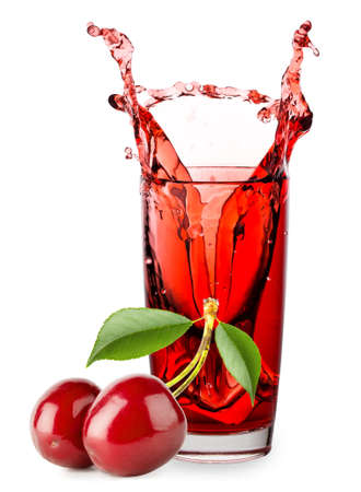 Glass of cherry juice with splash and berriesの写真素材