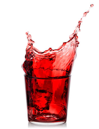 Splash of cherry juice in low glassの写真素材