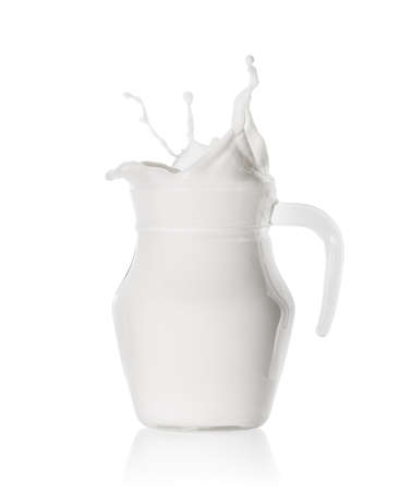 Splash of fresh milk in  glass jugの写真素材