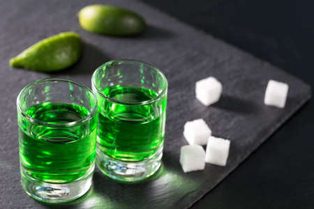 Glasses of absinthe with lime and sugarの写真素材