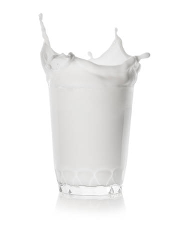 Splash in a low glass of milkの写真素材