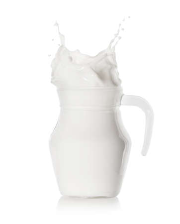 Splash of milk in a filled glass jugの写真素材