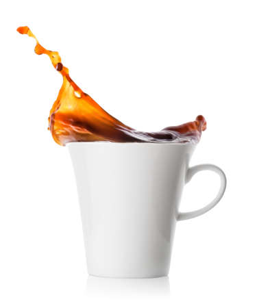 Splash coffee in white porcelain cupの写真素材