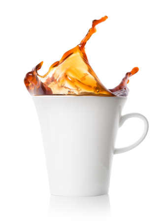 Splash in a white porcelain cup of black coffeeの写真素材