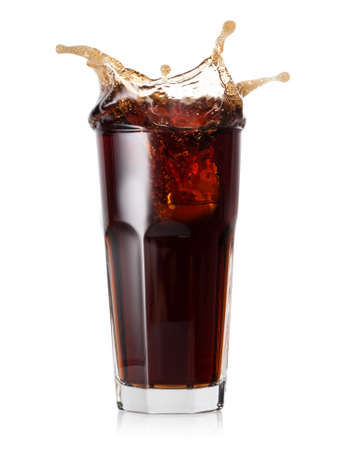 Glass of cold cola with a splash of ice cubes. Isolated on white background.の写真素材