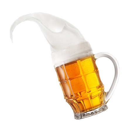 Mug of light beer with splashing foam. Isolated on white background.の写真素材