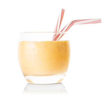 Glass of banana or vanilla smoothie or yogurt with strawsの写真素材