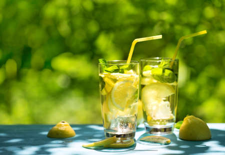 Two glasses of homemade lemonade on table on the streetの写真素材