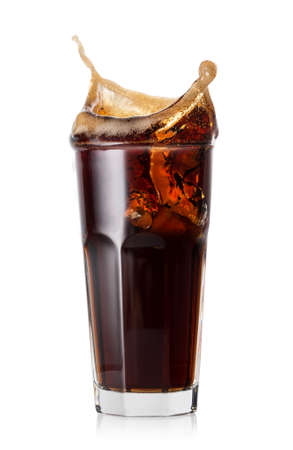 Splash of cola from ice cubes in glassの写真素材