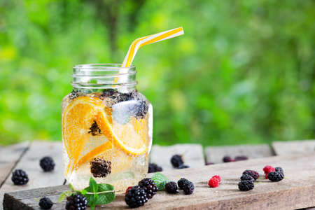 Cocktail lemonade from orange and berries in mason jarの写真素材