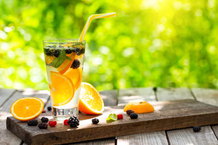 Citrus cocktail lemonade on table on sunny summer dayの写真素材