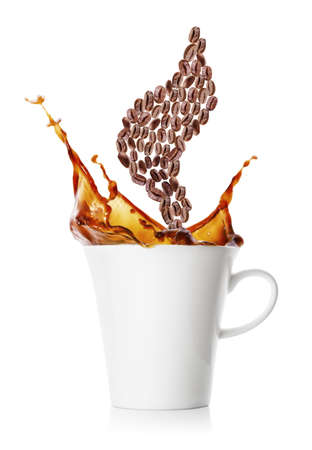 Coffee splash and steam from coffee beans over cupの写真素材