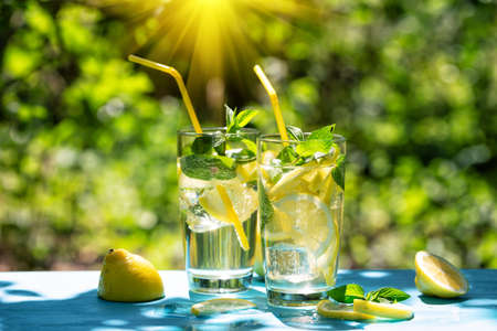 Lemonade and lemons on blue tableの写真素材