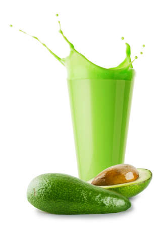 Green smoothie or yogurt with splash and cut avocadoの写真素材