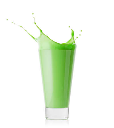 Splash in tall glass of green smoothie or yogurtの写真素材