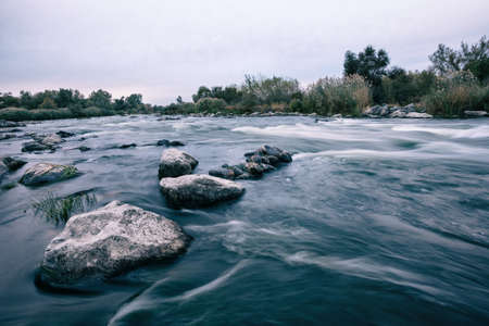 Stones on the shallows of mountain riverの写真素材