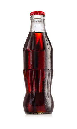 Brown carbonated drink in wet bottle with red capの写真素材