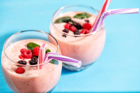 Glasses of berry smoothie with raspberry and mint berriesの写真素材