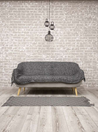 Brick wall and wooden floor with a sofa in the middleの写真素材