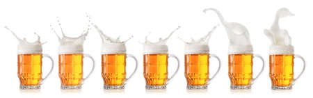 Splash of foamy light beer in mugの写真素材