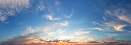 Sunset cloudy sky with orange sunの写真素材