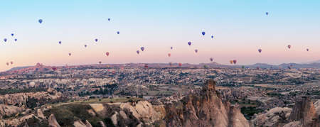 Multicolored balloons over the valley of Goreme at the dawnの写真素材