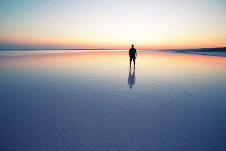 Salt lake Tuz with man leaving at sunsetの写真素材