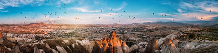 Panorama of Cappadocia with balloons at sunsetの写真素材