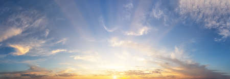 Sunset cloudy sky with the orange sun. Panorama. Preparation for the design projectの写真素材