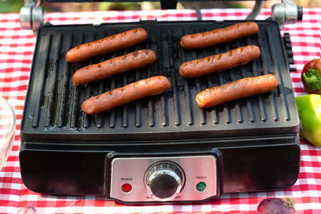 Grilled sausages on electric grill