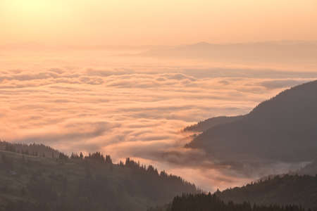 Clouds in mountains at sunriseの写真素材