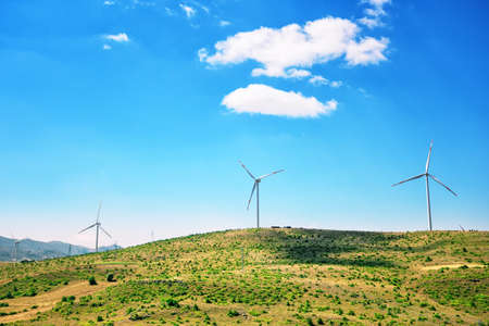 Wind generators on a plain under a blue skyの写真素材