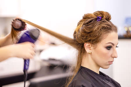 Beautiful young girl at the hairdresserの写真素材