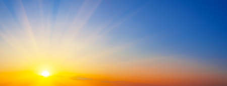 Panorama of dramatic sunset sky with sunbeamsの写真素材