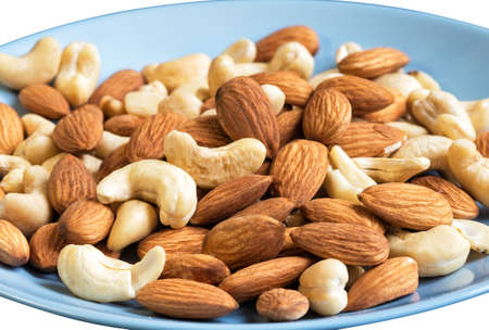 Mix of cashew and almond nut on blue plateの写真素材