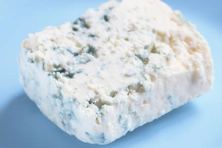 Piece of blue cheese on blue plateの写真素材