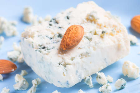 Blue cheese and almonds on blue plateの写真素材