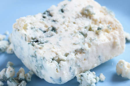 Dor blue cheese with mold on blue plateの写真素材