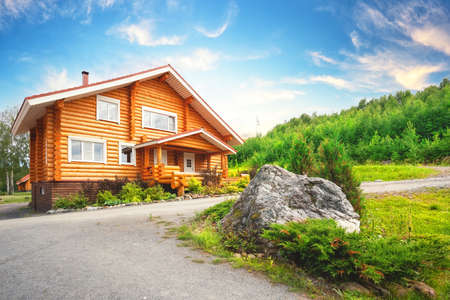 Wooden house on the lawn with stoneの写真素材