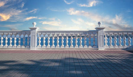 White decorative fence made of concrete with columns on seashoreの写真素材