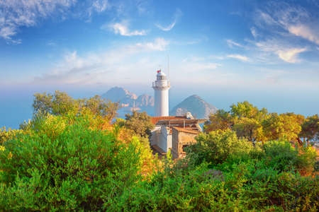 Lighthouse at Cape Gelidonia among green treesの写真素材